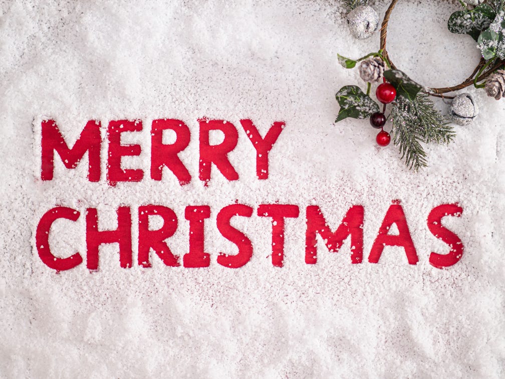 Santa standing in living room with greeting arms